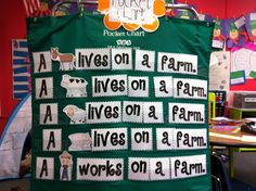 a green bulletin board with farm animals on it in an office cubicle area,