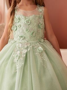 Step into a world of fairy-tale elegance with the Celine Glitter Tulle Girls Dress, a dazzling creation that's sure to make any little girl feel like royalty. The dress features an illusion neckline bodice that combines the magical allure of transparency with the security of full coverage, creating a sophisticated and modern silhouette. Adorning this ethereal bodice are delicate 3D flowers with beads, artfully placed to bring a garden of enchantment to life. The glitter tulle skirt is nothing sh Flowers With Beads, Baby Christening Outfit, Celine Dress, Girls Communion Dresses, Girls Crown, Flower Girl Crown, Christening Outfit, Girls Pageant Dresses, Christening Dress