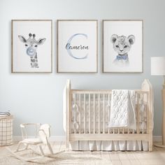 a baby's room with three framed pictures on the wall