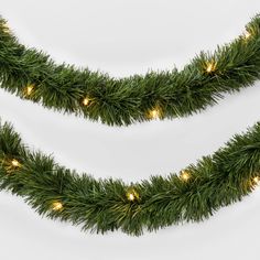 two christmas garlands with lights on them