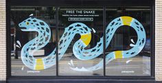 the window is decorated with an image of a snake on it's side and words free the snake