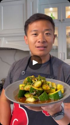 a man holding a plate with vegetables on it