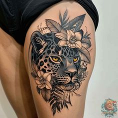 a woman's thigh with a leopard and flowers on it