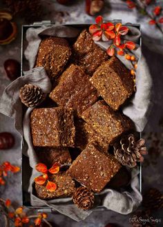 brownies in a box with pine cones on the side