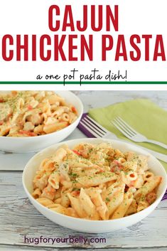 two white bowls filled with chicken pasta on top of a wooden table