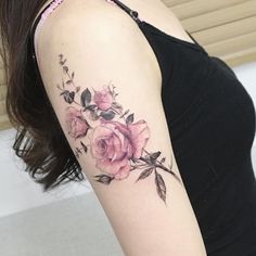 a woman's arm with pink roses on it