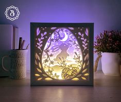 an illuminated paper cut out of a rabbit in the woods