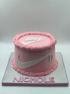 a pink nike cake with the number 11 on it