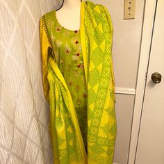 Pakistani Indian Three Piece Beautiful Formal Suit .Brand Sana Safinaz Brand New. Fabric Is Self Print Jacquard. Shirt Have Beautiful Hand Embroidery On Bottom And Arm.Mirror Work Spread All Over The Shirt.Shawl Have Tussles Trouser Plain Sz Approx Bust 22” Waist 20.5” Hip 23” Trouser 38” This Suit Is Perfect For Eid Or Diwali Or Christmas Brand New Festive Green Unstitched Suit With Printed Motifs, Yellow Fitted Anarkali Set With Printed Motifs, Fitted Yellow Anarkali Set With Printed Motifs, Fitted Yellow Printed Anarkali Set, Fitted Green Sets For Festive Occasions, Semi-stitched Green Churidar With Printed Motifs, Yellow Block Print Straight Kurta, Yellow Straight Kurta With Block Print, Yellow Fitted Anarkali Set With Straight Kurta