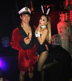 two people dressed up in costumes posing for the camera