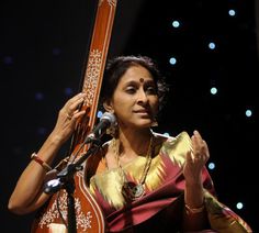 a woman holding an instrument in her hands