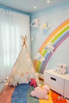 a child's room with a teepee tent, teddy bears and rainbow wallpaper