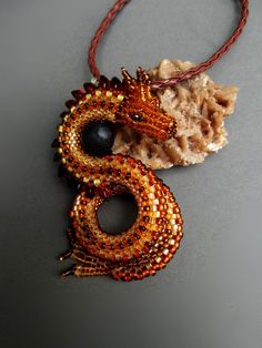 Original pendant depicting a dragon guarding an egg. Made with great care and precision from Toho, Miyuki and Czech FP beads, the dragon egg is an agate ball. The whole thing is hung on a braided strap 48 cm / 18.9inch long Dragon height 8cm / 3.14inch dragon width 4 cm / 1.57inch I can make a dragon in other colors - just write to me:) Fantasy Beaded Jewelry As Gift, Beaded Dragon, Long Dragon, Fantasy Jewellery, Make A Dragon, Dragon Lover, Dragon Egg, Dragon Pendant, Beaded Animals