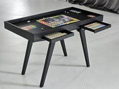 a table with two games on it and one drawer open to reveal the contents inside