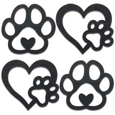 four pieces of black metal with hearts and paw prints on the front, one has a heart