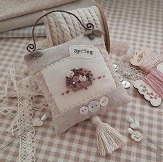 a close up of a bag on a table with buttons and other items around it