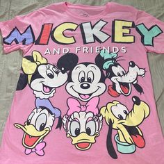 Disney Mickey & Friends T-Shirt Size Small Brand New Never Worn Disney Style T-shirt With Cartoon Print For Disney Trips, Playful Cartoon Print T-shirt For Disney Trips, Pink Fun T-shirt For Disney Fan Events, Casual Multicolor T-shirt For Disney Trips, Disney Crew Neck T-shirt With Funny Print, Multicolor Cotton T-shirt For Disney Trips, Cute Pink Mickey Mouse Tops, Cute Pink Mickey Mouse Top, Disney Character Print T-shirt For Disney Fan Events