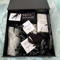 an open box with black and white items in it