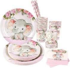 a set of pink and white plates with elephants on them