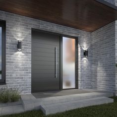 the front door to a modern house is lit up by two lights on either side