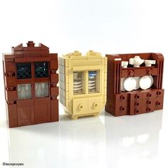 three legos sitting next to each other in front of a white background and one is brown