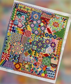 a multicolored patchwork quilt is displayed on a colorful background with white border