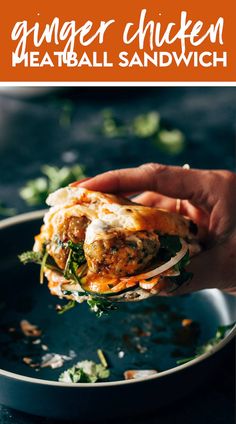 a person is holding up a sandwich with meat and vegetables on it in a pan