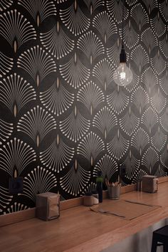 a bar with wooden counter tops and black wallpaper