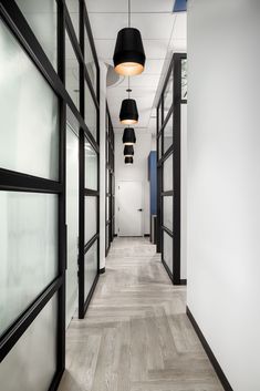 an empty hallway with black and white accents