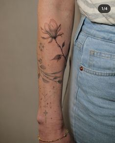 a woman's arm with a flower tattoo on the left side of her arm