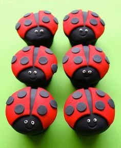 four red and black ladybug cupcakes sitting on top of each other