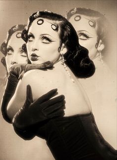 three women wearing gloves and makeup are posing for the camera