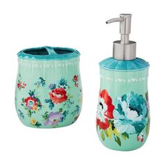 a soap dispenser and toothbrush holder with flowers painted on the front