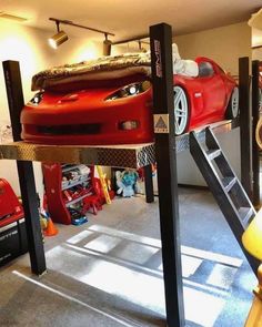 there is a red car on top of the bunk bed