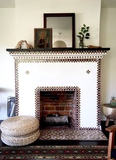 a living room with a fire place and rug