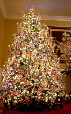 a brightly lit christmas tree in a living room