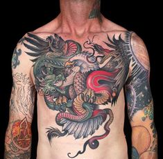 a man with tattoos on his chest and arms