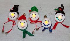 five snowmen with christmas lights on their heads are shown in the shape of ornaments