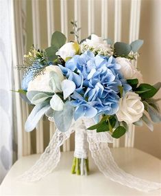 a bouquet of blue and white flowers on a table