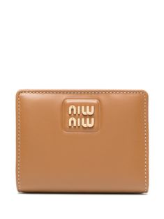 caramel brown leather gold-tone logo lettering bi-fold design press-stud fastening internal logo stamp internal card slots coin pocket Brown Rectangular Wallet With Logo, Gold Leather Wallet With Logo Plaque, Leather Wallets With Gold-tone Logo For Everyday Use, Luxury Brown Wallet With Logo Plaque, Classic Gold Wallet With Logo Plaque, Gold Bifold Wallet, Luxury Brown Wallets With Logo, Leather Bifold Wallet With Logo, Brown Wallets With Logo For Everyday Use