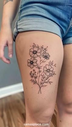 a woman's thigh with flowers tattooed on the side and behind her butts