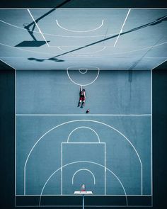 an overhead view of a basketball court with two people on it