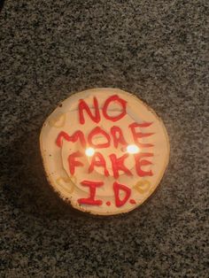 a cake with the words no more fake i d on it sitting on a table