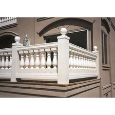 a balcony with white balconies and railings on the side of a building