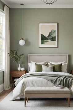 a bedroom with green walls and white bedding, an art piece on the wall