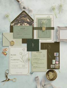 the wedding stationery is laid out neatly on top of each other, including cards and envelopes