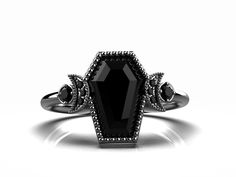 KINDLY LEAVE YOUR CONTACT NUMBER AT THE TIME OF PLACING ORDER FOR SHIPPING PURPOSE. RING DETAILS: AAA NATURAL ONYX GEMSTONE BLACK RHODIUM PLATED 925 STERLING SILVER RING GEMSTONE SHAPE- COFFIN GEMSTONE TYPE - ONYX GEMSTONE GEMSTONE SIZE- 10.00 MM X 7.00 MM BLACK SPINEL ACCENTS GEMSTONE SETTING - PRONGE TYPE RING TYPE - IT'S AN ONYX GEMSTONE 925 ROSE PLATED STERLING SILVER ENGAGEMENT RING PLATING TYPE- BLACK RHODIUM OCCASIONS : WEDDING RING, ENGAGEMENT RING, RING, FLOWER RING FOR HER, PROPOSAL RI Gothic Adjustable Rings For Formal Occasion, Gothic Style Adjustable Rings For Formal Occasions, Adjustable Gothic Style Rings For Formal Occasions, Gothic Formal Adjustable Rings, Elegant Silver Halloween Jewelry, Round Onyx Jewelry For Anniversary, Gothic Oval Rings For Formal Occasions, Oval Onyx Wedding Ring, Black Oval Gothic Jewelry