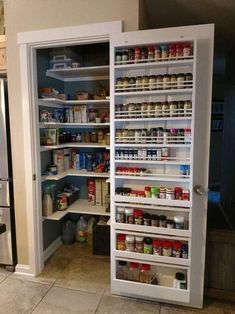 an open pantry door in a kitchen filled with food