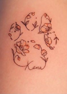 a woman's back with flowers and leaves on the side of her stomach tattoo