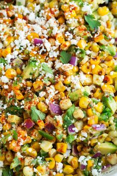 corn salad with cilantro, avocado and feta cheese on top